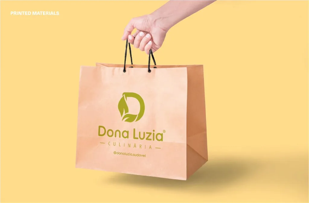 Printed materials: Dona Luzia kraft paper shopping bag held in hand